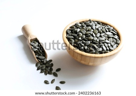 Natural green pumpkin seeds without shell isolated on white background. Healthy food concept. Overhead view. Copy space. Royalty-Free Stock Photo #2402236163
