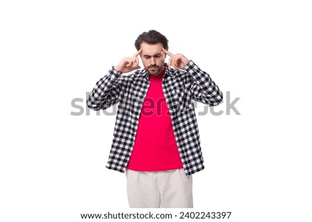 brainstorm. young handsome bearded brunette man in a shirt generates ideas in his head on a white background with copy space