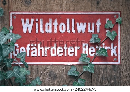 German Sign " Wildtollwut Gefaehrdeter Bezirk " meaning wild rabies prone district.