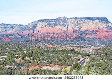 A panoramic view of Sedona, Arizona, with the Wilson Mountain in the background and taken from high up on the Hogwash hiking trail. Royalty-Free Stock Photo #2402255043