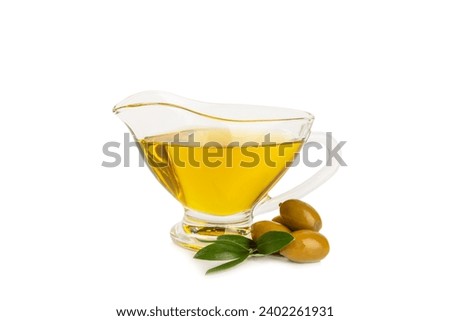 Bowl of fresh olive oil and olives with leaves isolated on white background. Delicious olive oil in a glass bowl. olive oil bottle. Royalty-Free Stock Photo #2402261931
