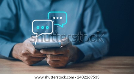 Technology, communication, Social media text messaging concepts, Businessman using smartphone texting message while sitting on table with in work office.	 Royalty-Free Stock Photo #2402269533