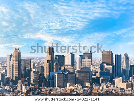 Panoramic view of a strip of skyscrapers overlooking the buildings of the western district of Shinjuku with the Tokyo City Hall along with all the businesses that make up Japan's economic nerve center Royalty-Free Stock Photo #2402271141