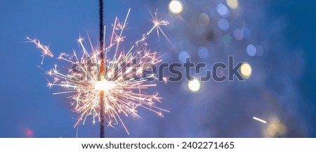 Beautiful sparklers made of sparklers on a New Year's bokeh background, on a blue background, Christmas mood, banner, glitter, holiday background.
