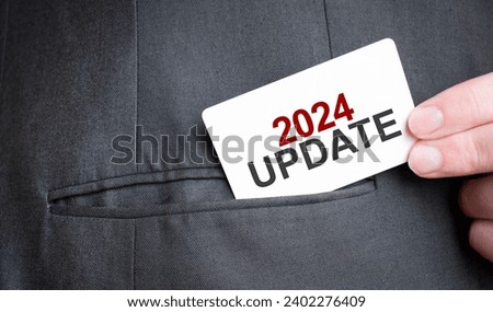 Card with 2024 update text in pocket of businessman suit. Investment and decisions business concept.