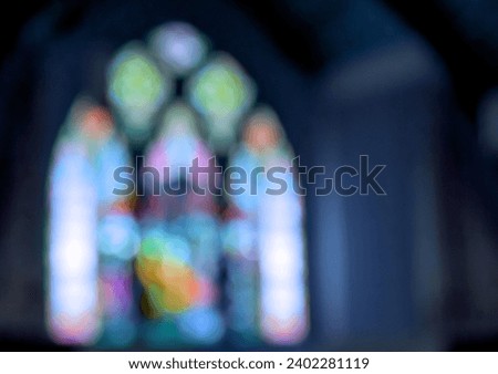 stained glass window arches with bokeh blur and blue tint Royalty-Free Stock Photo #2402281119