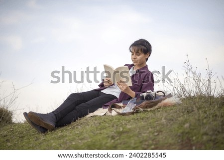 Young and beautiful lady sitting, reading a book, resting, walking, taking photos in an open area