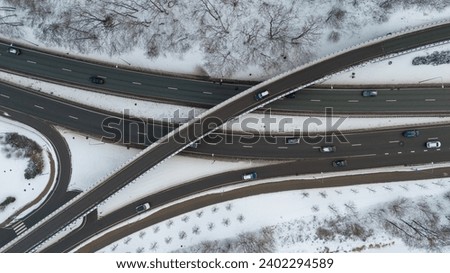 Drone photography of multiple lane highway with overpass in a city during winter day