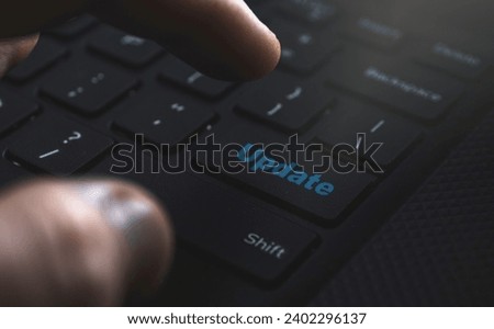 Close-up: Hand on keyboard, clicking 'Update' button. Streamlined upgrades for a seamless user experience. High quality photo