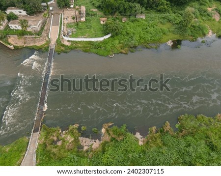 drone shot aerial view top angle panoramic photograph of Vaigai dam reservoir irrigation project india tamilnadu madurai tourism river mountain Bridge turquoise blue water cloudy wallpaper background 