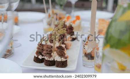 A beautiful festive table covered with a variety of food. Food and drinks on the festive table in the restaurant on birthdays, weddings. Beautifully decorated banquet table with appetizers.