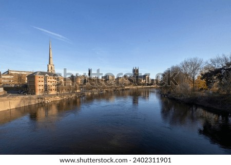 A calm autumn morning looking across the River Severn in Worcester, Worcestershire, UK Royalty-Free Stock Photo #2402311901