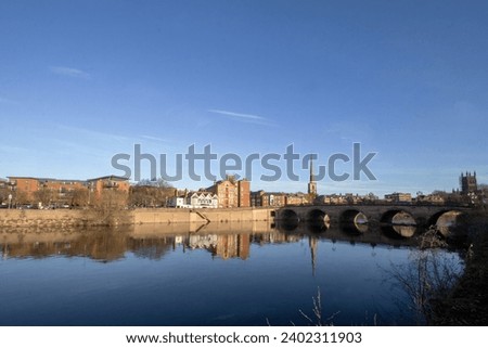 A calm autumn morning looking across the River Severn in Worcester, Worcestershire, UK Royalty-Free Stock Photo #2402311903