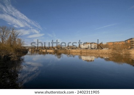 A calm autumn morning looking across the River Severn in Worcester, Worcestershire, UK Royalty-Free Stock Photo #2402311905