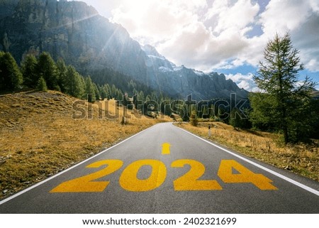 2024 New Year road trip travel and future vision concept . Nature landscape with highway road leading forward to happy new year celebration in the beginning of 2024 for bliss and successful start . Royalty-Free Stock Photo #2402321699