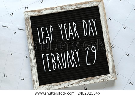 Leap Year Day, February 29, message board flat lay on calendar pages - concept for event that happens every four years.  Royalty-Free Stock Photo #2402323349