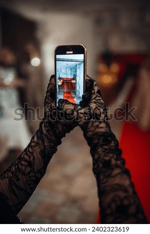 The woman takes a picture with a mobile phone during night party