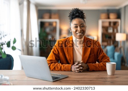 Happy smiling businesswoman small business owner, company leader or sales manager, female CEO executive, successful entrepreneur looking at camera sitting in home office. Royalty-Free Stock Photo #2402330713