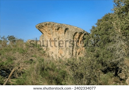 Strange shaped granite boulder eroded and gradually worn away by time Royalty-Free Stock Photo #2402334077