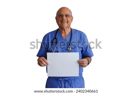 Bald caucasian male doctor wearing blue scrubs holding blank white sign and smiling on a white background