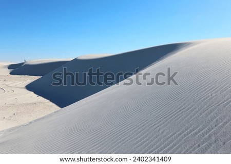 Beautiful gypsum sand dune scenery at White Sands National Park from Alkali Flats Trail. Royalty-Free Stock Photo #2402341409