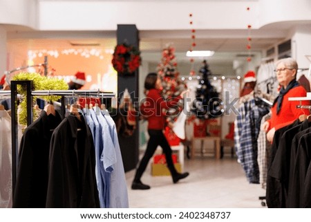 Old client searching for formal attire in clothing store, buying clothes from clearance section at shopping center. Woman looking for gifts during christmas holiday, giving presents to family.
