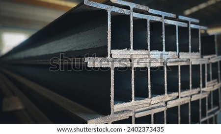 Metal profiled steel beams are packed at the metal products warehouse, H-beam steel and Wi-Frank steel. For large structures or building columns Royalty-Free Stock Photo #2402373435