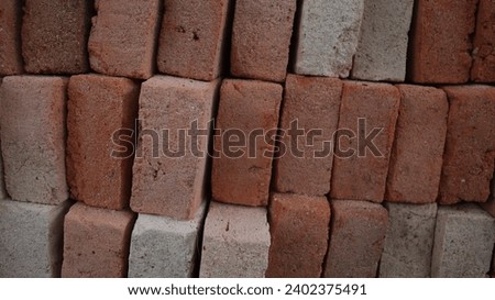 Close view of A stack of red clay bricks for house construction