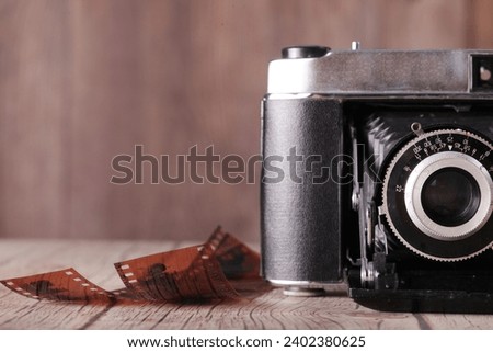 Antique film folding camera and old film, close-ups
