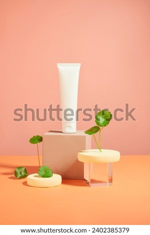 Template for cosmetic mockup displayed on pink background with gotu kola leaves, geometries podiums. Scene for advertising cosmetic of gotu kola extract with minimal concept. Front view