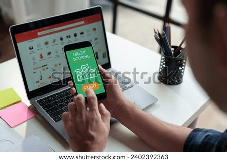 Male businessman, independent entrepreneur uses mobile phone through smartphone application to chat online. Online booking, podcast, cashback, business transactions via mobile phone in modern office.