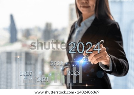 Businesswoman with a modern visual screen 2024 global network connection Graph analyzing financial growth and business planning concept