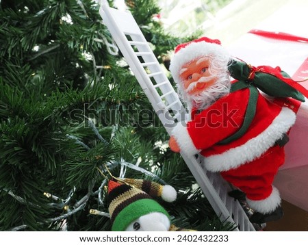 Santa Claus is climbing a white ladder on a Christmas tree.
