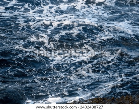 Sea with waves and rocks on the shore Royalty-Free Stock Photo #2402438727