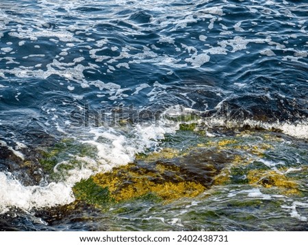 Sea with waves and rocks on the shore Royalty-Free Stock Photo #2402438731