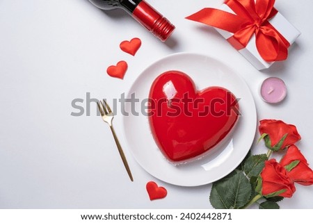 Valentines day. heart shaped glazed valentine cake, gift and champagne on white background