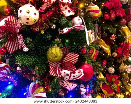 Christmas tree decorated candy toy, gold and red ball with lights. New Year celebration concept.