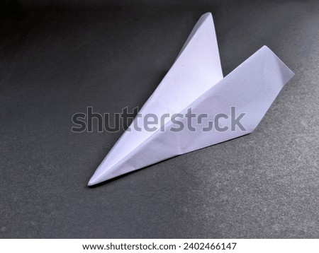 Airplane craft made of paper on a black background