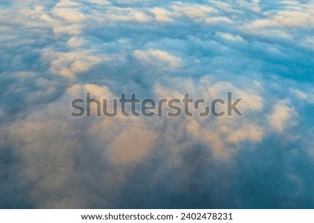 drone aerial view of a cloud covered valley at sunset, golden hour