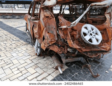 2022 Russian invasion of Ukraine war torn city destroyed car burn out. Russia war damage building destruction city war ruins city damage car. Disaster area. cars beaten by shrapnel and burnt Royalty-Free Stock Photo #2402486465