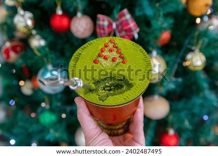 Traditional Brazilian chimarrão prepared with yerba mate (Ilex paraguariensis) decorated with a Christmas theme and with brazilwood seeds