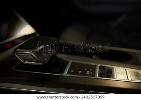 Selector automatic transmission with leather in the interior of a modern expensive car. The background is blurred. Black and brown leather car