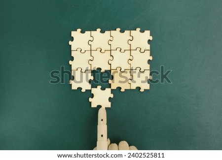 The wooden puzzle is arranged and completed. Concept of complex and smart logical thinking. Slightly defocused and close up shot. Copy space.

 Royalty-Free Stock Photo #2402525811