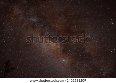 The Milky Way shines brilliantly in the night sky, adorned with a hint of orange, as seen from Mount Raung, Banyuwangi, on August 19, 2023. A celestial spectacle painting the darkness with cosmic hues