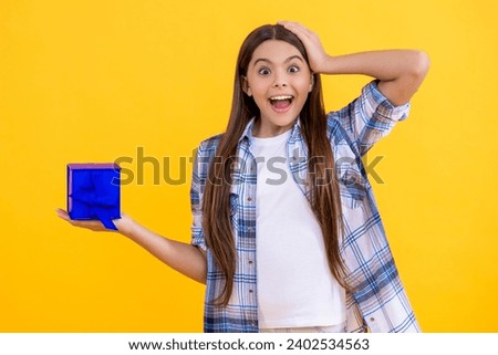 amazed teen girl holding present box with excitement at birthday party. teen girl holding a present wrapped. teen girl show present on a special occasion. teen girl with present