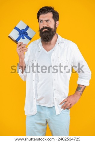 photo of pondering birthday man with purchase box. caucasian birthday man with purchase