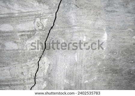 vertical cracked cement wall. cracked concrete wall