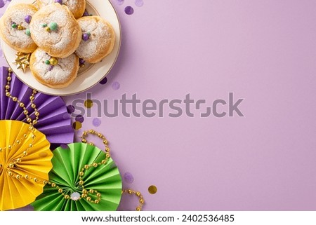 Whimsical Carnival Affair: top view festive tableau of fans, ribbon star, confetti, and beads garlands on a purple backdrop. Sweet donuts complete the Mardi Gras-inspired scene, perfect for promotions