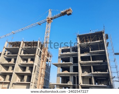 Under construction Buildings, Tower crane  are erected with sides of building, Building with blue sky background, 02 building beside each other