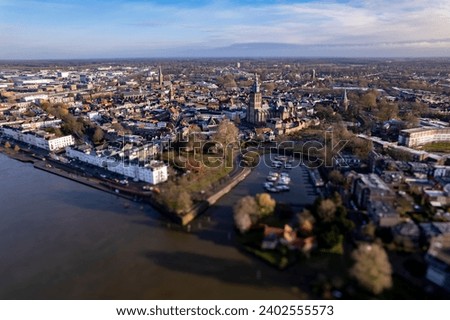 Countenance city facade view fro above during extreme high water level of river IJssel in Zutphen, The Netherlands, against a clear blue sky. Aerial weather and climate concept. Royalty-Free Stock Photo #2402555573